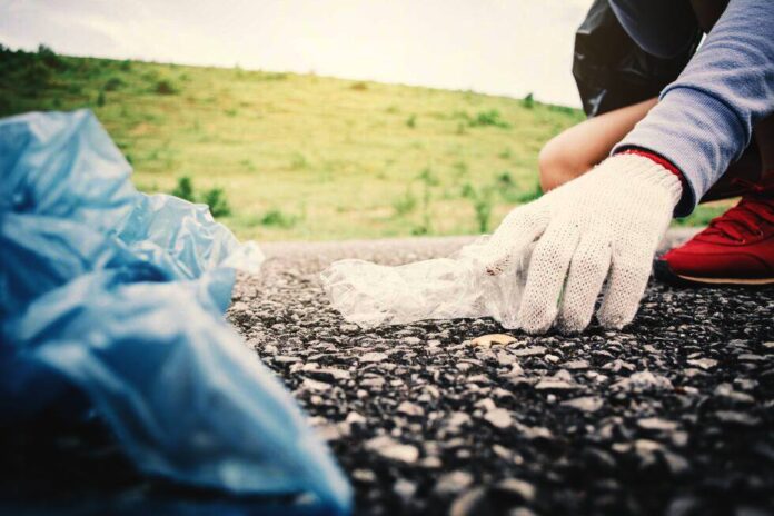 midsection-person-wearing-glove-while-collecting-g