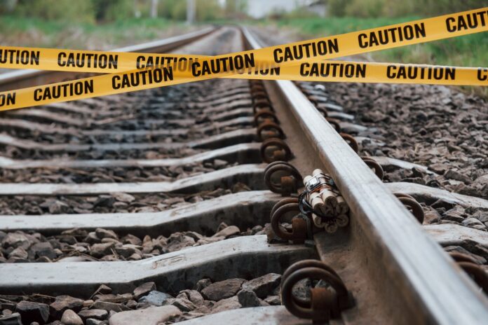 be-aware-dangerous-explosive-lying-railway-yellow-caution-tape-front_146671-16666