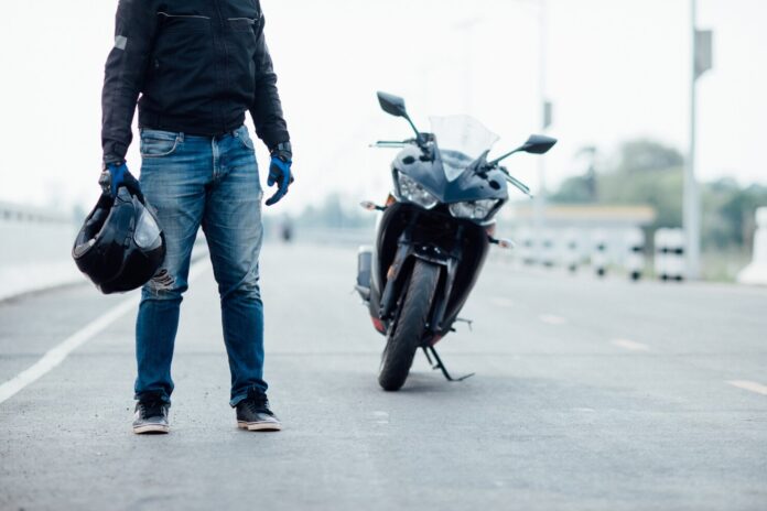 handsome-motorbiker-with-helmet-hands-motorcycle_1150-10692