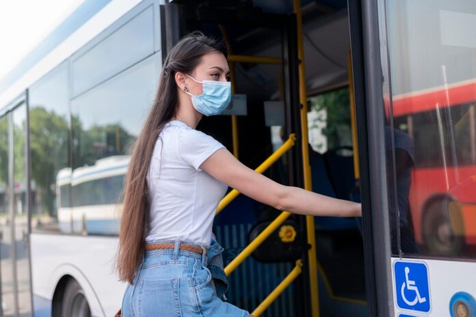 woman-with-medical-mask-using-public-bus-transportation_23-2149043009