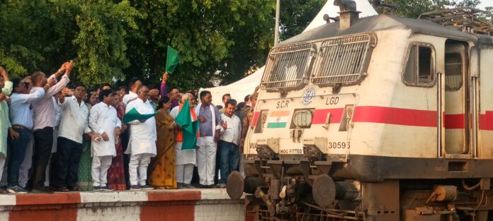 राज्य मंत्री ट्रेन को हरी झंडी दिखाने की तस्वीर