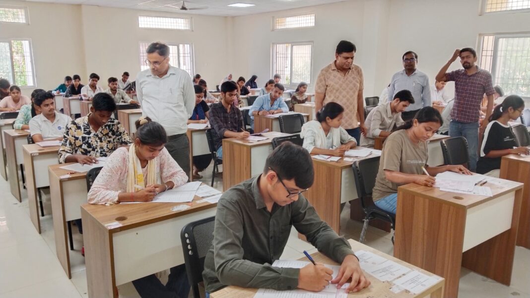 पीयू कैट परीक्षा केंद्र पर चेकिंग करते हुए शिक्षक पीयू कैट परीक्षा केंद्र पर चेकिंग करते हुए शिक्षक
